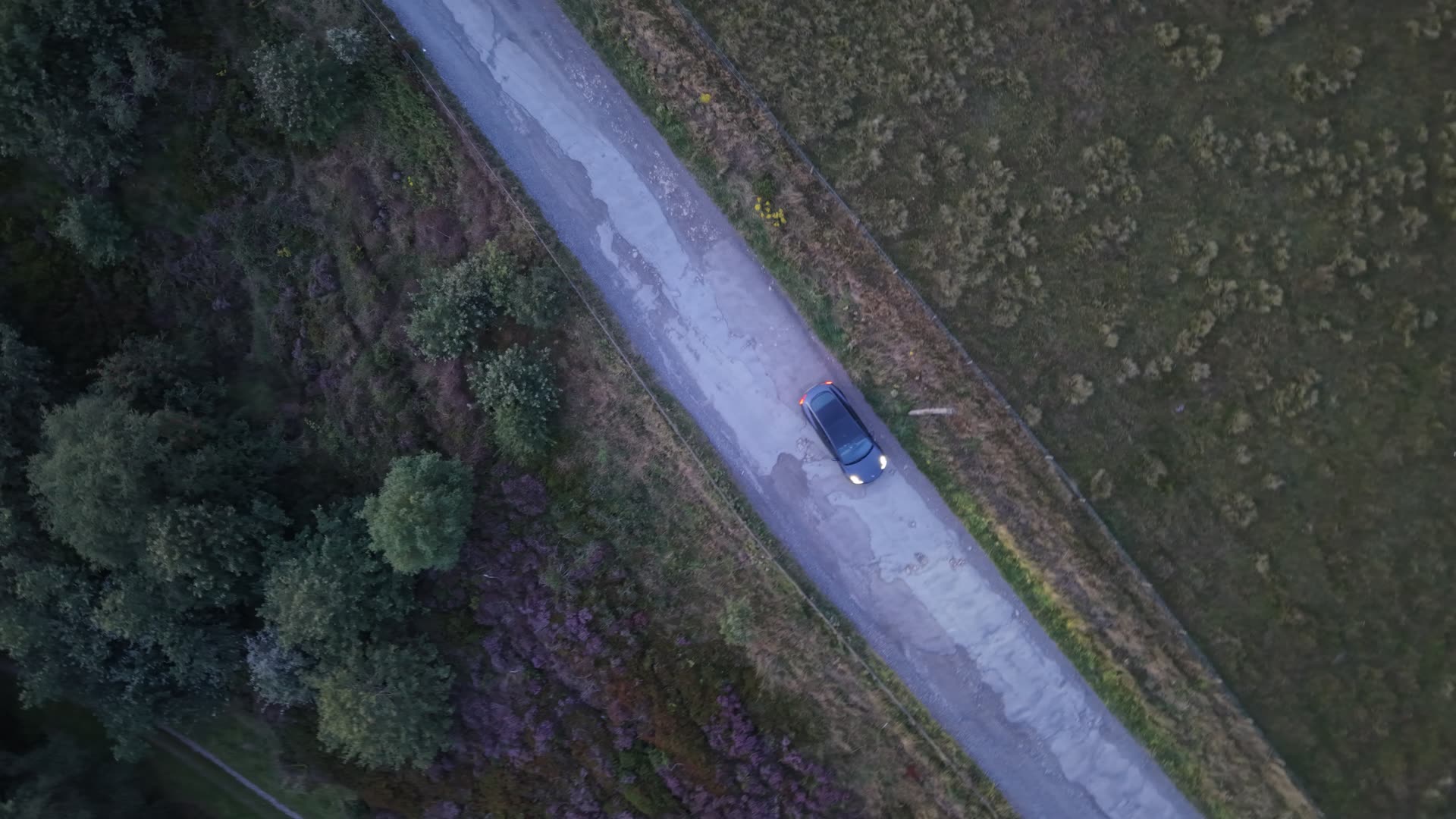 A drone feed shown full-screen on a car dashboard